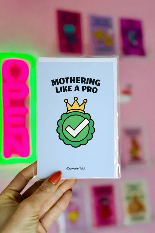 Mother’s Day card featuring a green checkmark badge with a gold crown and the text “Mothering Like a Pro” on a blue background.