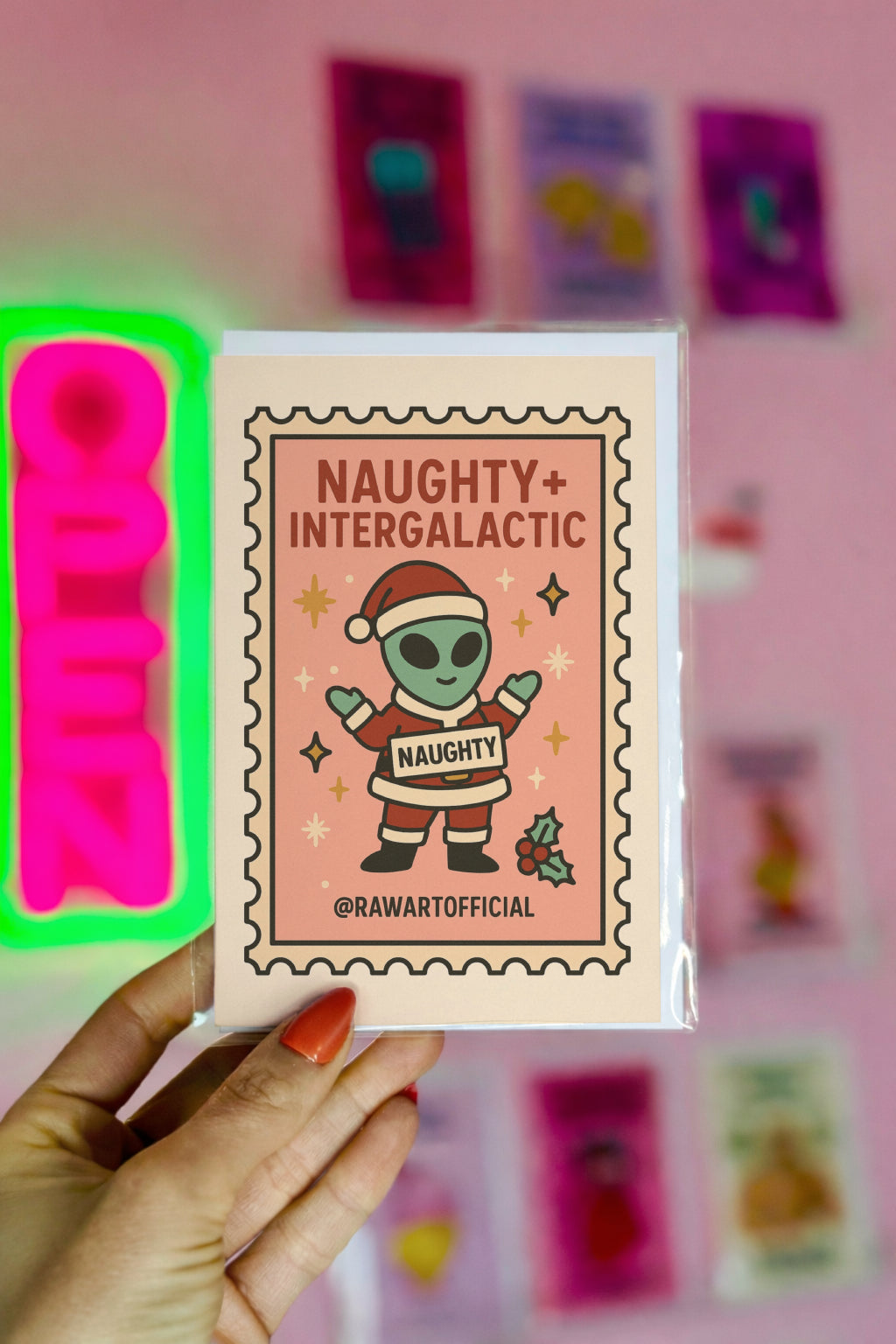 Funny alien in Santa suit holding naughty sign, pink retro Christmas card stamp style.