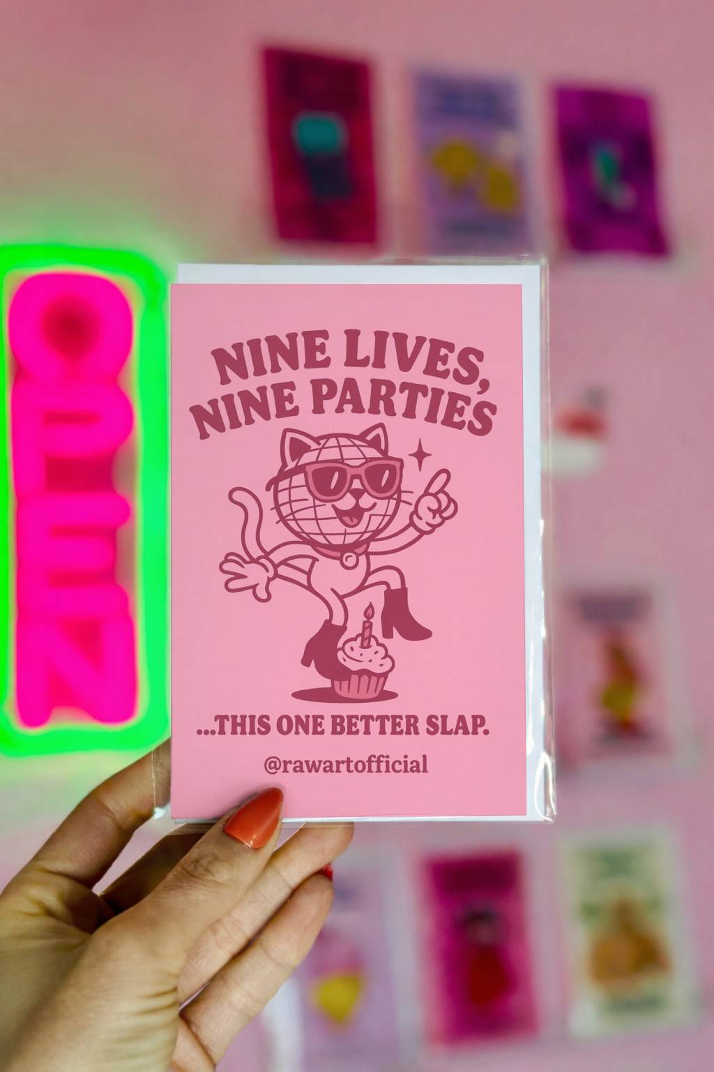 Pink birthday card featuring disco cat in sunglasses standing on cupcake with text “Nine Lives Nine Parties.”