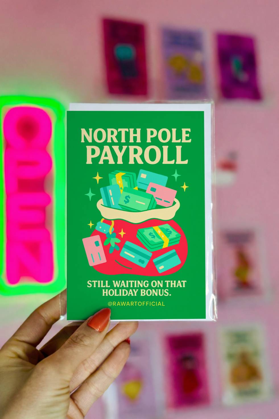 Funny Christmas greeting card showing a money sack filled with cash and cards with text reading “North Pole Payroll – Still Waiting on That Holiday Bonus.”