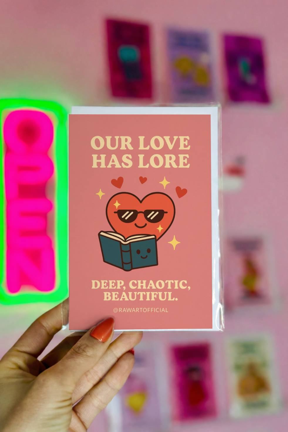Greeting card with a heart wearing sunglasses reading a book and text “Our Love Has Lore.”
