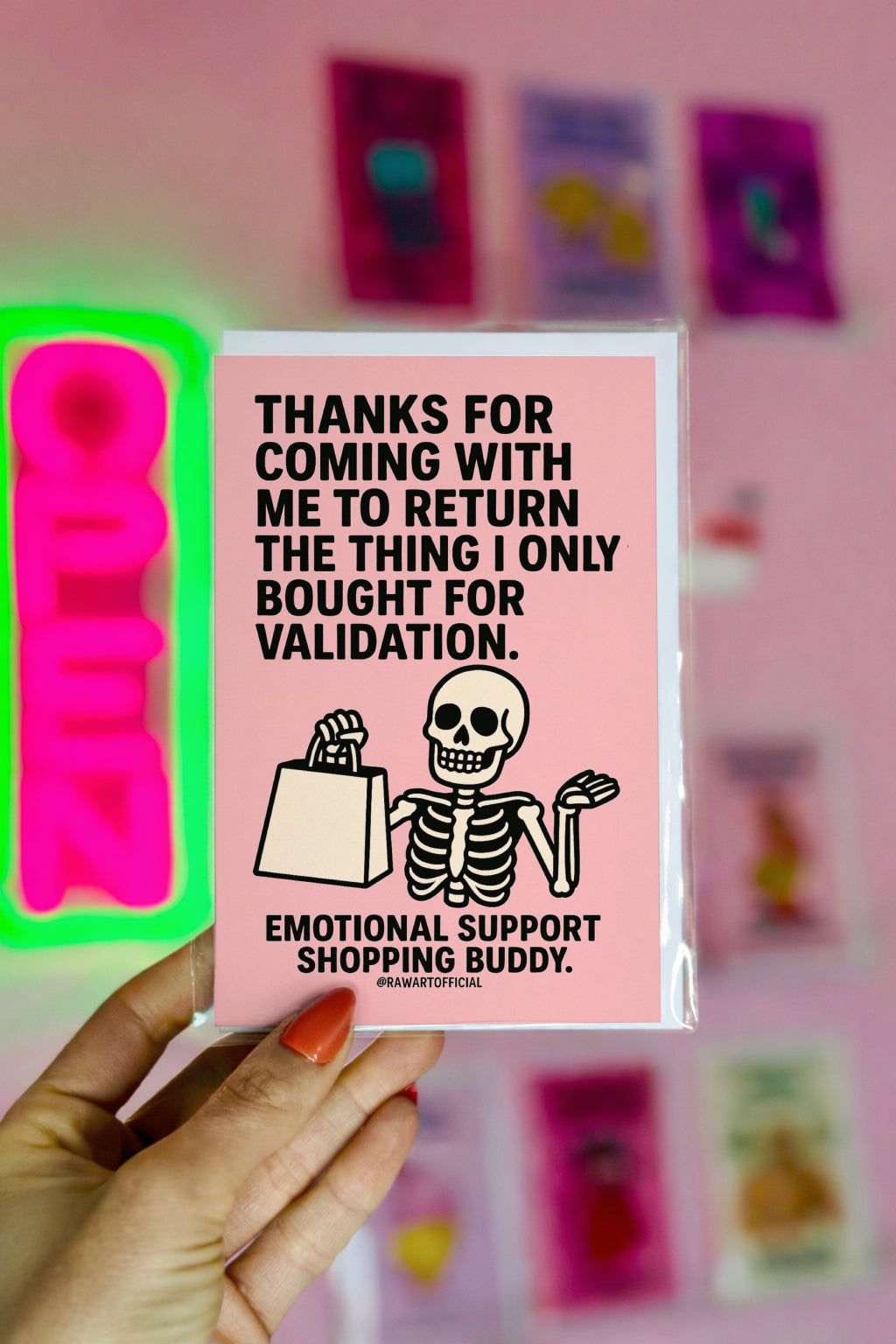 Pink card with smiling skeleton holding a shopping bag and text thanking someone for being the emotional support shopping buddy.