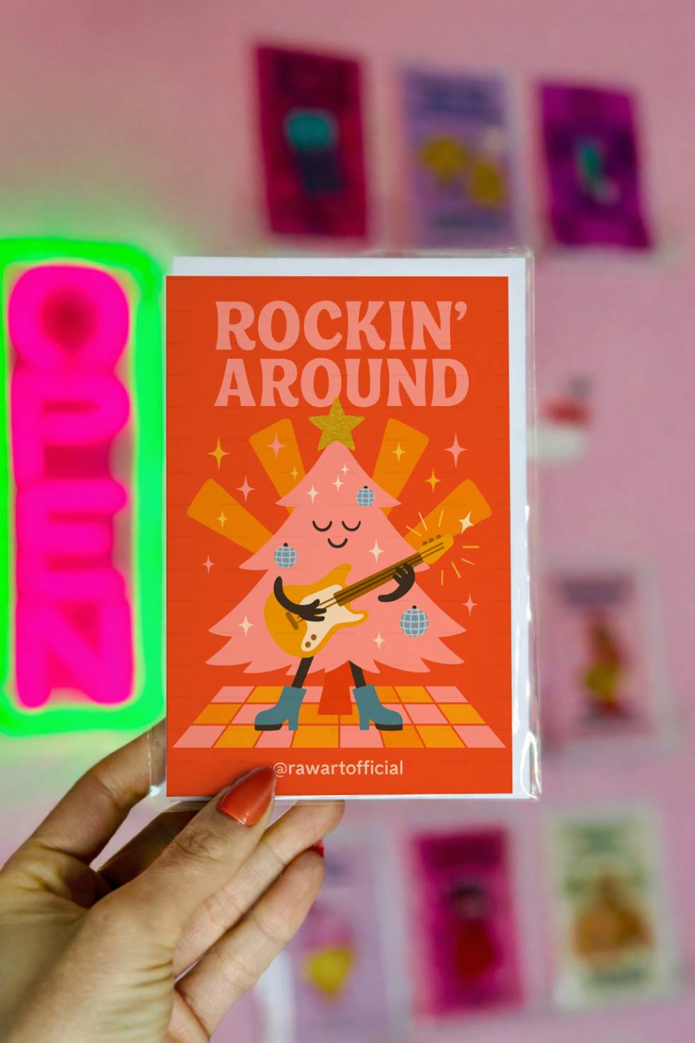Funny Christmas greeting card with guitar-playing Christmas tree and text “Rockin Around.”