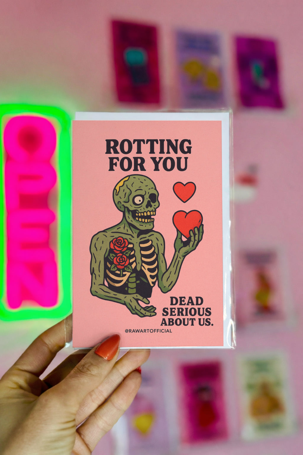 Cartoon zombie with roses in its ribcage holding red hearts, text reads “Rotting For You – Dead Serious About Us.”