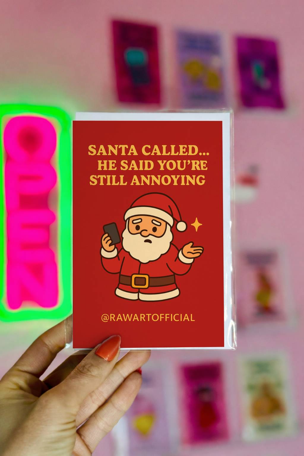 Funny Christmas card featuring Santa holding a phone with text “Santa called he said you’re still annoying” in a bold retro style design