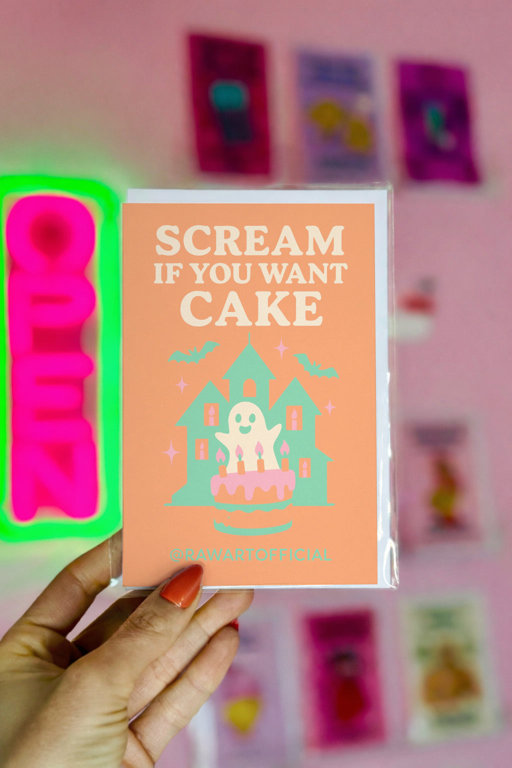 Pastel haunted house with ghost and birthday cake illustration, text reads “Scream If You Want Cake.”