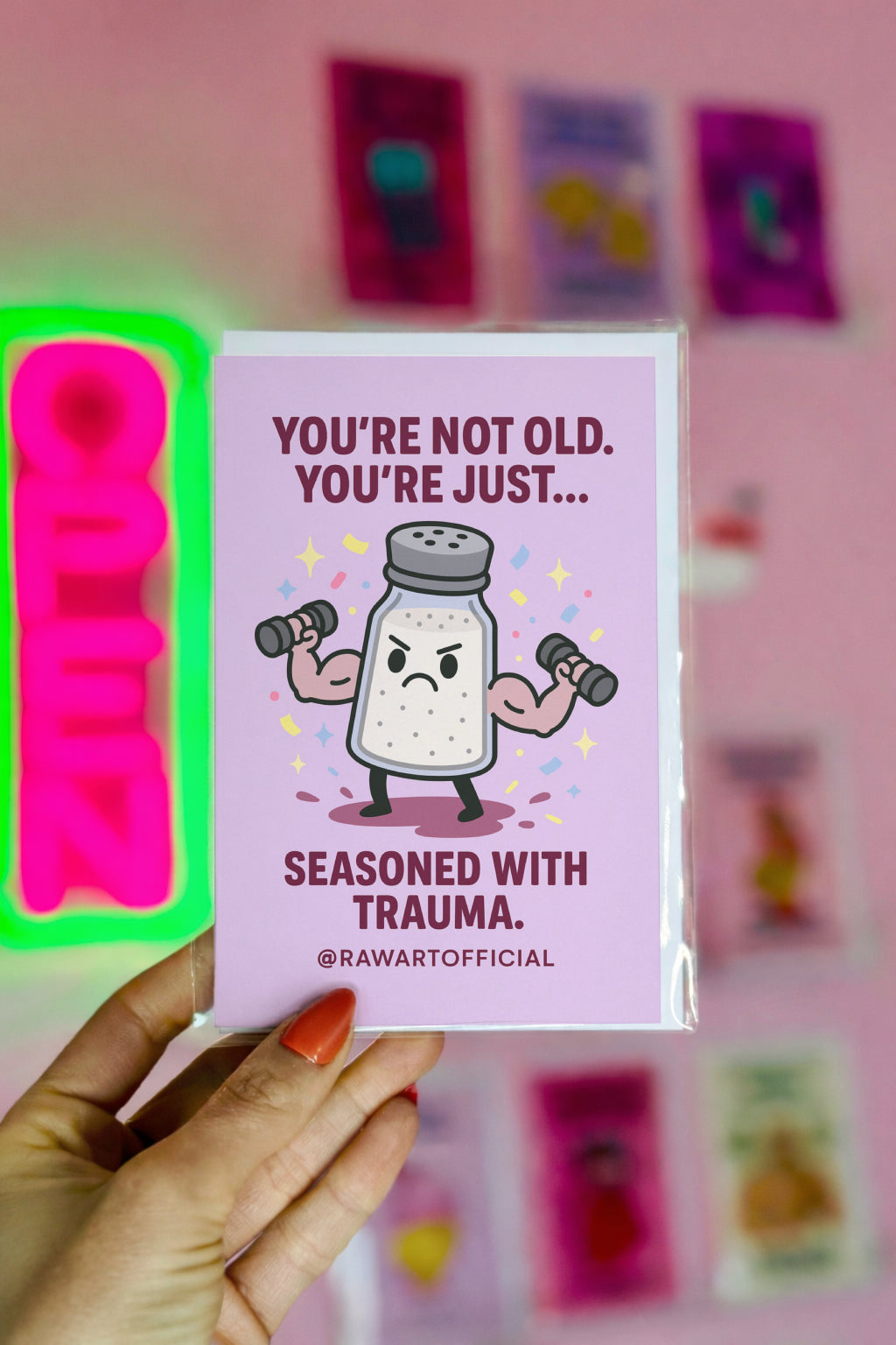 Buff salt shaker lifting weights with confetti and text: “You’re not old, just seasoned with trauma.”