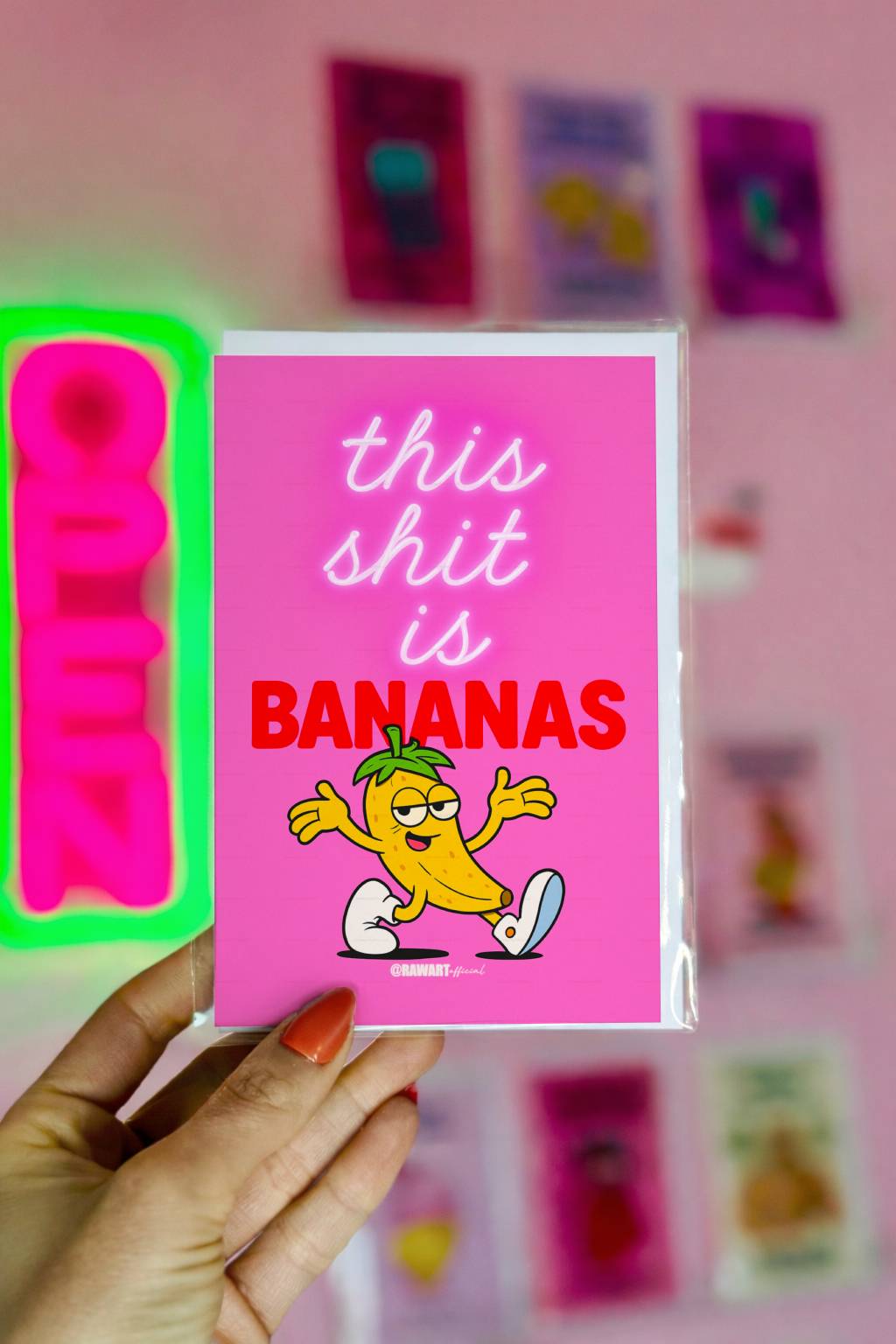 Bright pink funny card with cartoon banana and text This Shit Is Bananas.