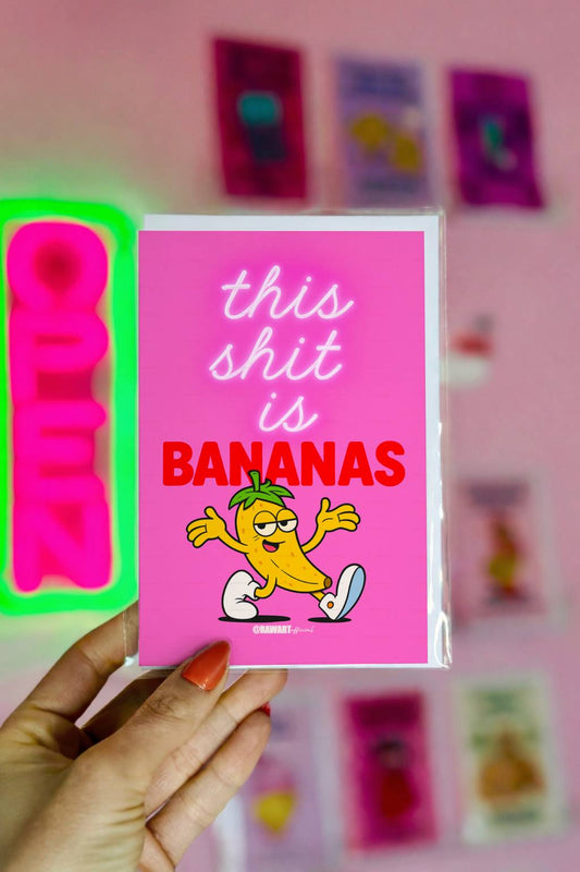 Bright pink funny card with cartoon banana and text This Shit Is Bananas.