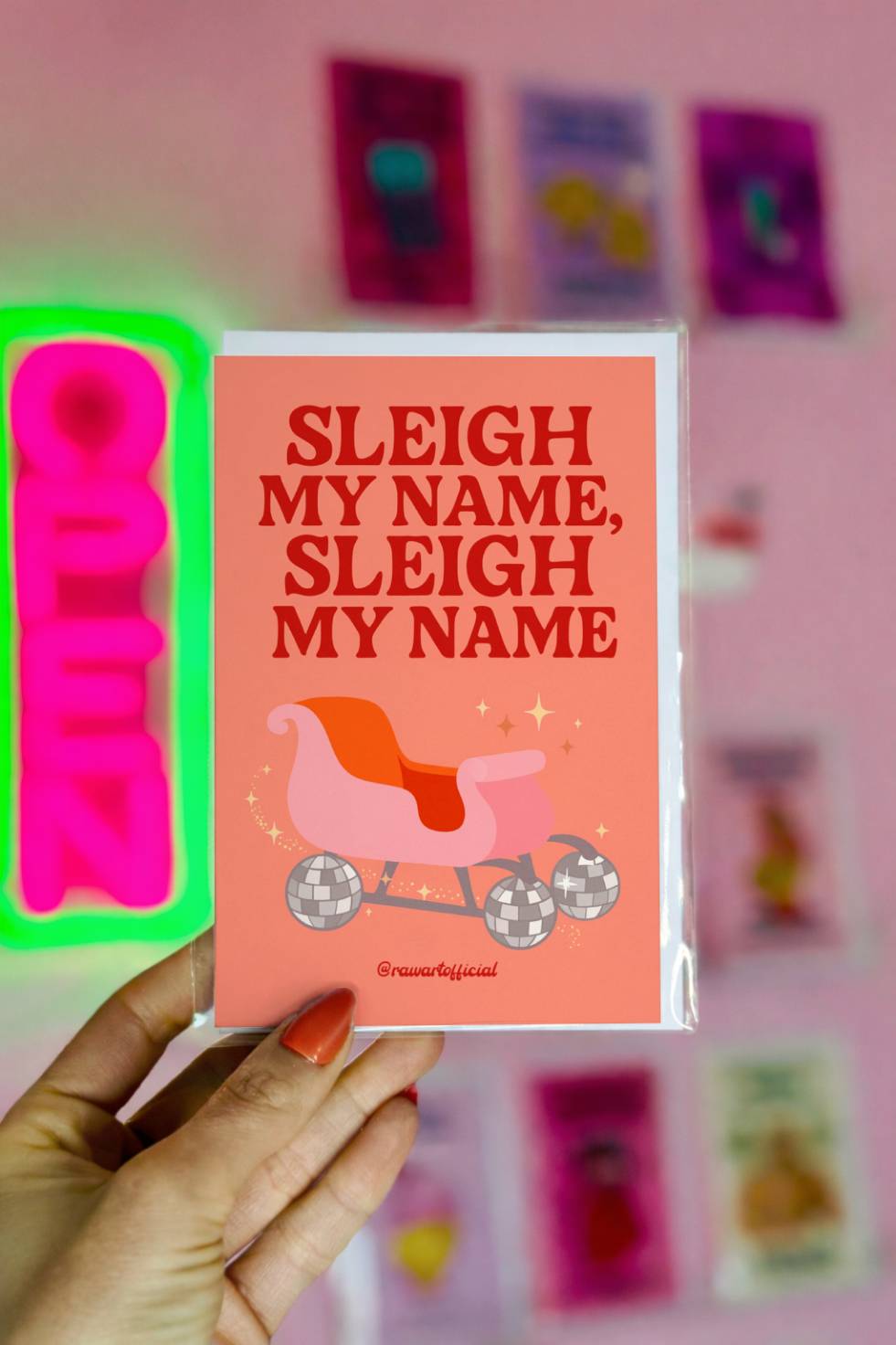 Funny Christmas greeting card with sleigh on disco-ball wheels and text “Sleigh My Name Sleigh My Name.”
