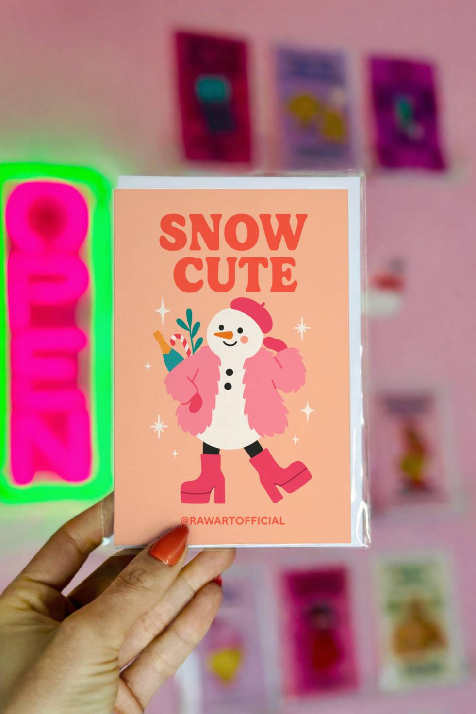 Funny Christmas greeting card with fashionable snowman in pink coat and boots and text “Snow Cute.”