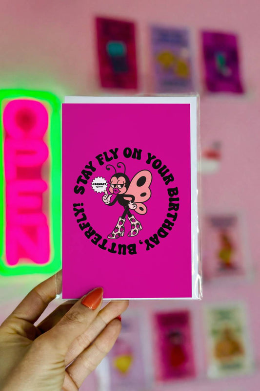 Hot pink birthday card featuring retro butterfly in platform boots with circular text reading “Stay Fly on Your Birthday, Butterfly.”