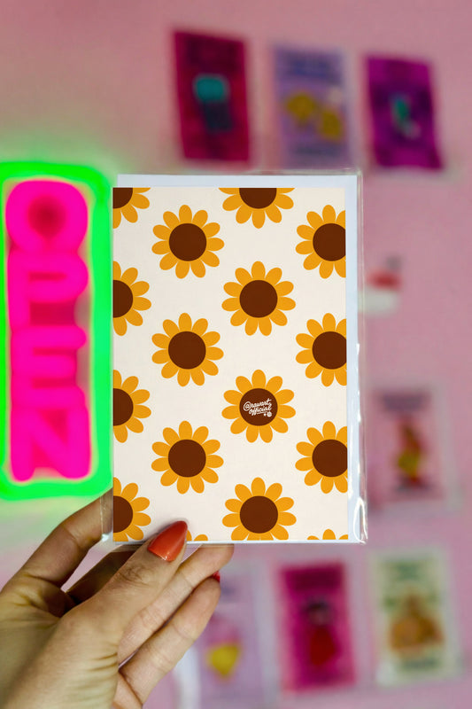 Mother’s Day greeting card featuring a bold retro sunflower pattern with mustard yellow petals and brown centers on a cream background, signed @rawartofficial.