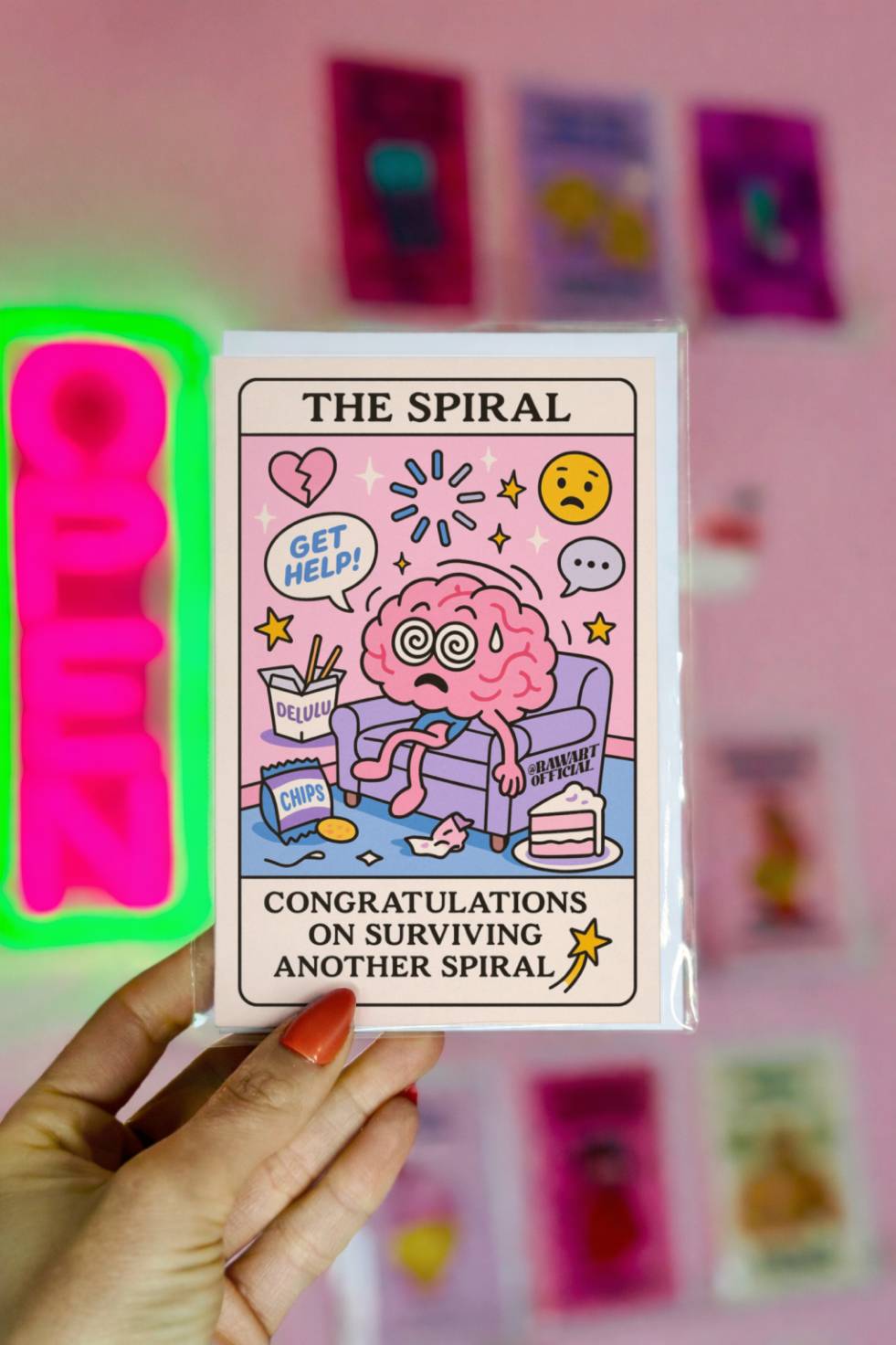 Funny tarot-style birthday card titled “The Spiral” with a frazzled brain character on a couch surrounded by snacks and text “Congratulations on Surviving Another Spiral.”