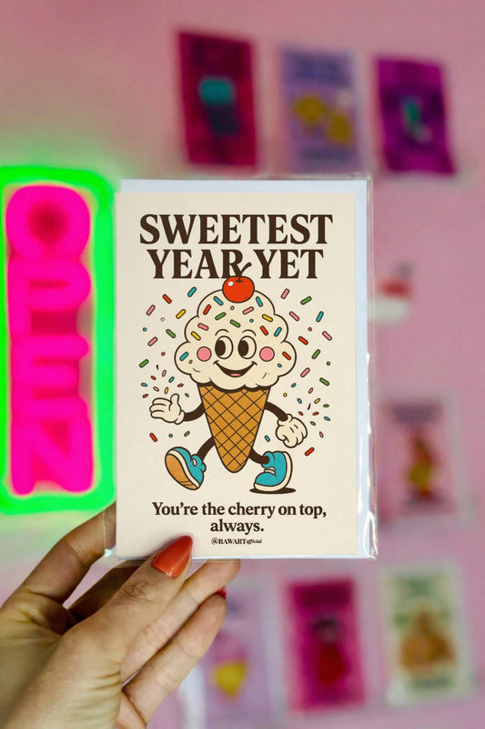 Cream birthday card featuring retro ice cream cone with sprinkles and cherry with text “Sweetest Year Yet.”
