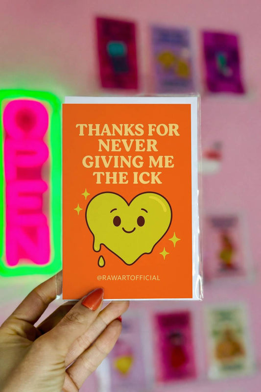 Orange greeting card with cream retro text reading Thanks for Never Giving Me the Ick and smiling green heart illustration with @rawartofficial signature.