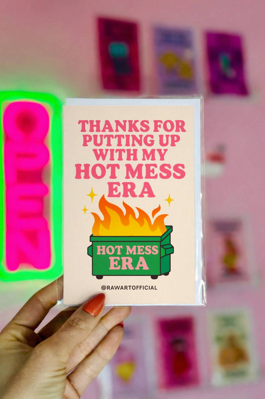 Greeting card featuring a flaming dumpster labeled “Hot Mess Era” with the text “Thanks for Putting Up With My Hot Mess Era.”