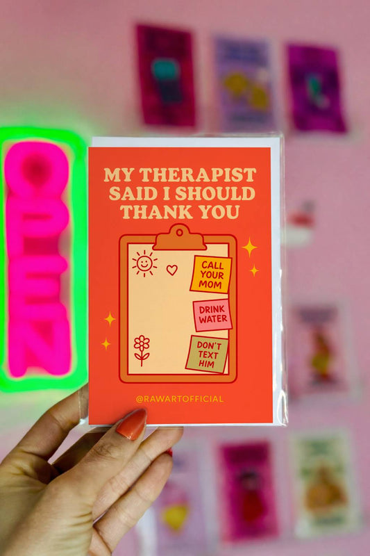 Greeting card featuring a clipboard with sticky notes reading “Call Your Mom,” “Drink Water,” and “Don’t Text Him” with the text “My Therapist Said I Should Thank You.”