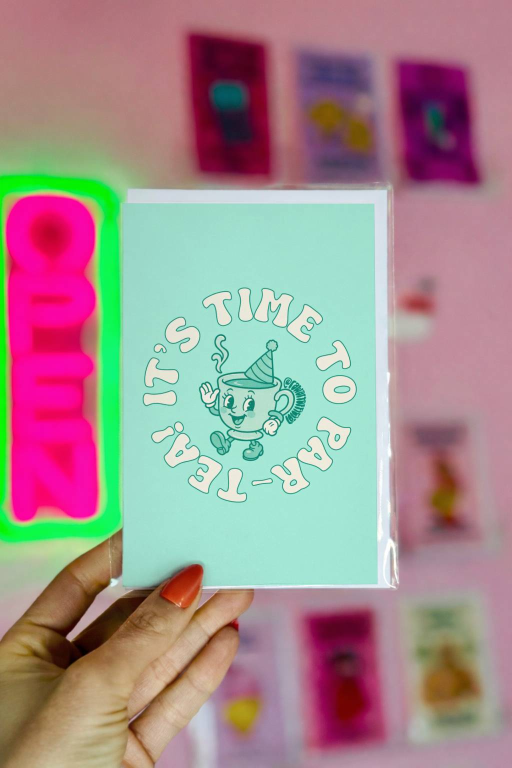 Mint green birthday card with retro teacup wearing party hat and circular text reading “It’s Time to Par-Tea.”