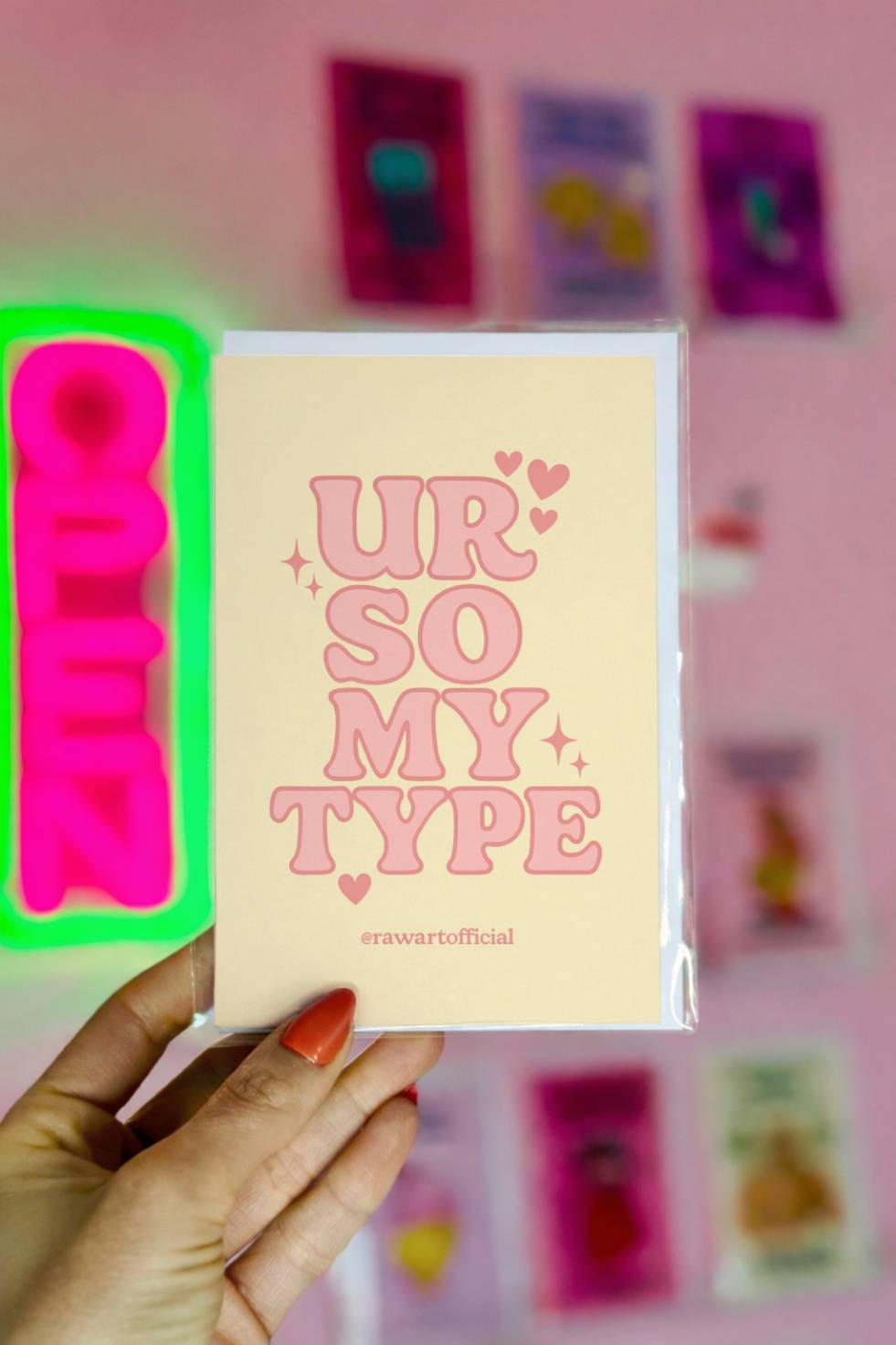 Cute greeting card with retro pink lettering reading “Ur So My Type” on a soft yellow background with hearts.
