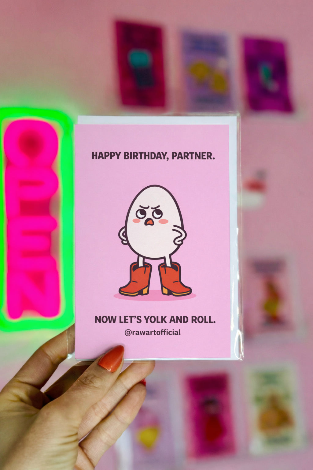 funny birthday card with an egg wearing cowboy boots on a pink background partner birthday food pun illustration