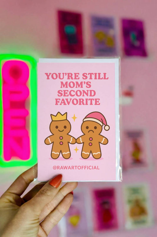 Funny Christmas card with two gingerbread siblings and text “You’re Still Mom’s Second Favorite.”